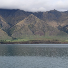 A view of mountains from a boat on Lake Wakatipu.